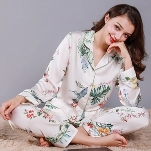 Women's silk satin long-sleeve pajamas set featuring bird and floral tropical prints