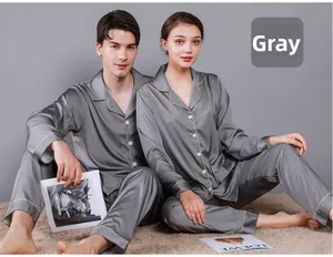 Detail of grey silk pajama sets with classic lapels and piping for couples in home setting