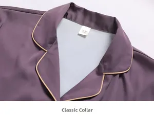 Close-up of silk pajama collar with contrast piping and premium satin texture