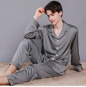 Detail of men's charcoal silk pajamas showing smooth texture and contrast piping