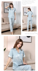 Detail of light blue silk pajama set with white floral pattern and lapel collar design