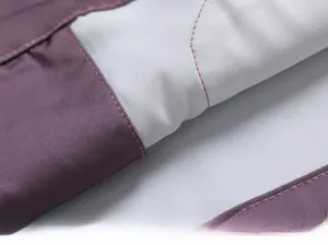 Detailed close-up of premium stitching and purple contrast fabric on silk pajamas