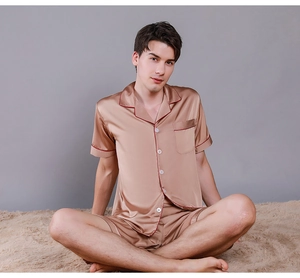 Detail of silk satin men's pajama set featuring contrast piping and button-down collar