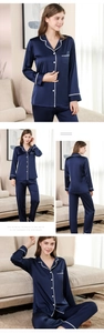 Detail of dark blue satin pajama set featuring white lace trim and button closure