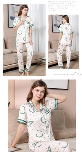 Detail of silk-like pajama set showing short-sleeve shirt and pants with letter pattern