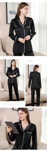 Detail of black silk pajamas with white lace scalloped edges and elegant contrast piping