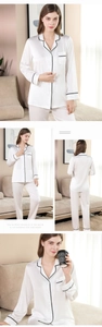 Detail of white silk pajama set with black wavy lace trim on collar and cuffs