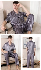 Detail of men's striped satin pajama set showing the smooth silk-like texture and vertical pattern