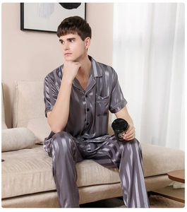 Close-up of men's striped satin pajama set showing fabric texture and contrast piping
