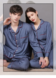 Detail of blue silk pajamas with houndstooth texture and red contrast piping