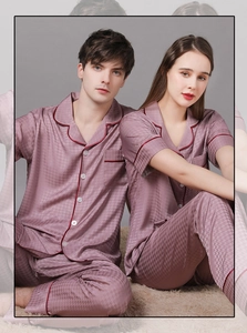 Close-up of gray silk couple pajamas with houndstooth pattern and contrast piping