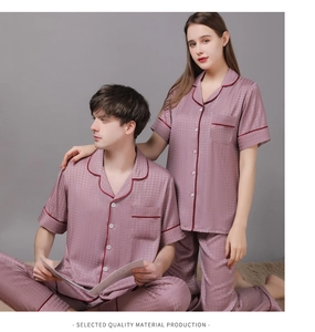 Detail of couple's ice silk pajama set featuring burgundy piping and houndstooth texture