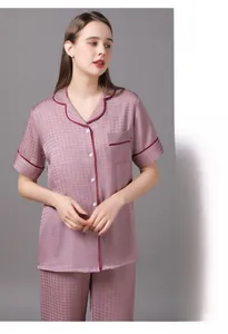 Close-up of women's short sleeve pajamas with houndstooth silk texture and contrast piping