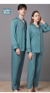 Detail of lake blue satin pajamas with houndstooth pattern and red piping accents