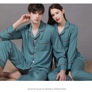 Detail of satin couple pajamas featuring houndstooth jacquard and red contrast piping