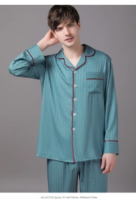 Detail view of teal silk pajamas with houndstooth pattern and contrasting red trim