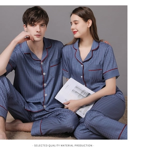 Close-up of silk pajama set featuring houndstooth pattern and red contrast piping detail