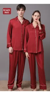 Detail of red silk pajama set with notched lapel and contrast piping for couples