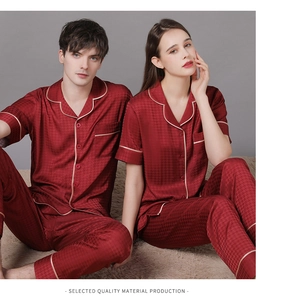 Detail of burgundy silk couple pajamas showing smooth fabric texture and contrast piping