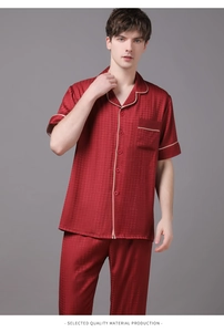 Close-up of men's burgundy silk pajama set with houndstooth pattern and contrast piping