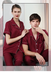 Close-up of burgundy striped satin pajamas with white contrast piping and lapels