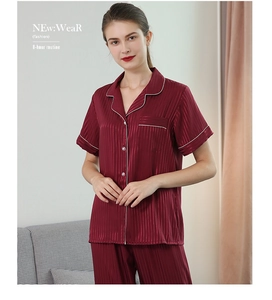 Detail of burgundy striped silk pajamas with short-sleeve button-down top and long pants