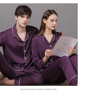 Detail of silk satin couple pajamas showing houndstooth texture and golden piping trim