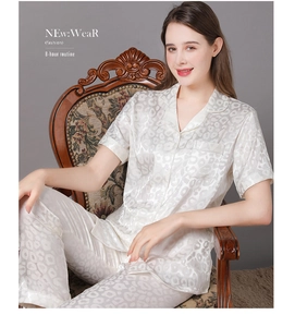 Detail of luxury silk short-sleeve pajama set with leopard print and satin finish