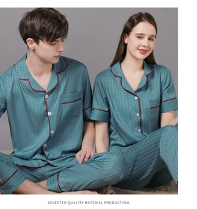 Close-up of silk-like houndstooth couple pajamas with elegant contrast piping detail
