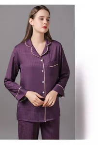 Detailed view of women's purple silk pajama set with fine texture and pink piping accents