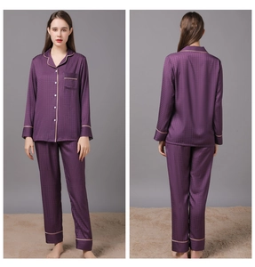 Detail of purple silk pajamas featuring jacquard fabric textures and contrast piping