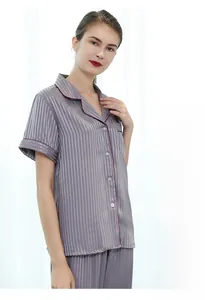 Detail of grey striped silk pajamas with red piping and smooth high-quality texture