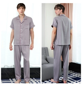 Detail of silk-like men's pajama set with vertical stripes and contrast piping