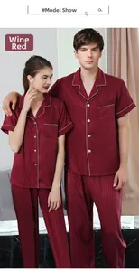 Detail of burgundy satin pajama set featuring white piping and vertical stripe texture
