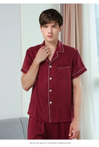 Close-up of men's burgundy striped satin pajama set with lapel collar and white piping