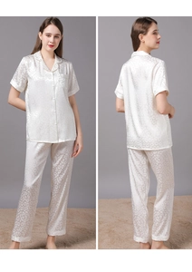 Close-up of women's cream leopard jacquard pajama set with glossy short sleeve top and pants