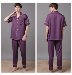 Detail of men's purple satin pajama set featuring silk texture and contrast piping edges