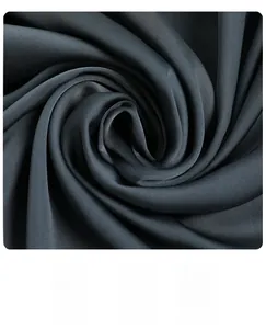 Macro shot of charcoal grey silk satin fabric showing smooth texture and luxury sheen