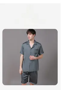 Detail of grey silk-like pajamas showing soft sheen fabric and chest pocket design