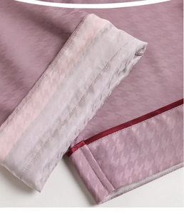 Detail of silk pajama sleeve with pink houndstooth pattern and contrast piping