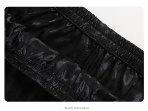 Close-up of elastic waistband on black satin pajamas with premium jacquard texture