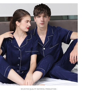 Detail of navy blue silk pajamas showing white piping and vertical stripe texture