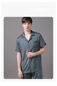 Detailed view of grey-blue satin pajama top with button-down collar and chest pocket
