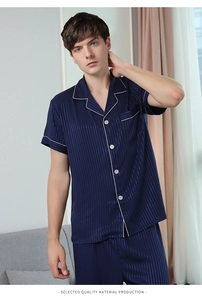 Detail of navy blue striped silk pajama set with white piping and chest pocket