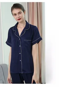 Detail of dark blue striped silk pajamas featuring white piping and high quality fabric