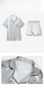 Detail view of light blue satin pajama set with white floral patterns and classic lapel