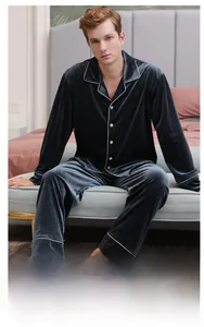 Close-up of premium velvet texture on men's dark gray long-sleeve pajama set with white piping