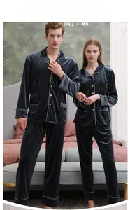 Close-up of tungsten gold grey velvet pajamas with white contrast piping and lapels