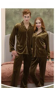 Detail of couple velvet pajamas in gold bronze showing the soft texture and piping finish