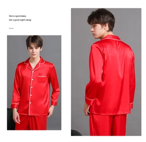 Detail of red silk men's pajama set featuring white piping and classic notched lapels